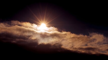 Sunlight breaking through dark clouds in a dramatic sky