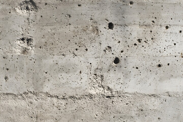 Weathered concrete wall surface shows texture and imperfections in urban environment