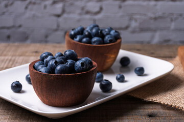 Rustic wooden bowls with blueberries.