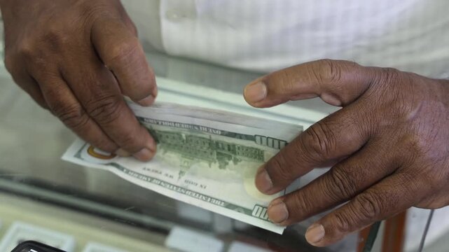 men's hands, dark skin, counting dollars