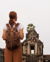 Backpacker Gazes at Angkor Wat Gopura with Palm, Cambodia Travel Concept