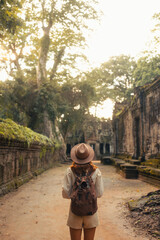 Female Traveler Walking Through Ancient Angkor Temple Passageway Ruins