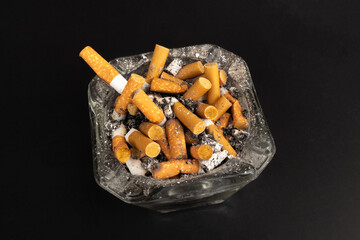 cigarette butts torn on black background ashtray