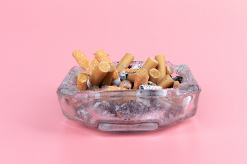 cigarette butts torn on pink background ashtray