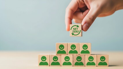 Building a sustainable team hand placing block with recycling symbol atop a hierarchy of people icons representing environmental responsibility