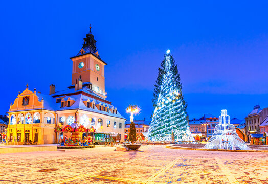 Brasov, Romania. Christmas Market in Main Square, with Xmas Tree, decorations and lights, Transylvanian landmark