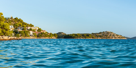 Croatian coastal landscape in the town of Tribunj, view over the sea to the nearby island with...