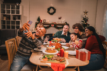 Family celebrates Christmas and New Year by exchanging gifts, sharing smiles and laughter, enjoying...