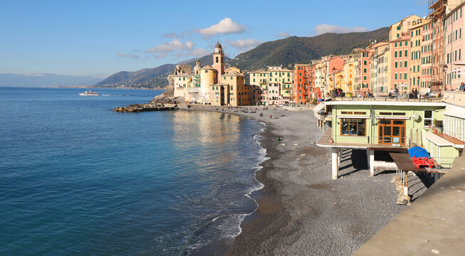 View of sea and coast on sunny day. Fishing village, Camogli, Italy. Tourism and recreation. Ecologically clean nature. Traditional old buildings. Historical centre.