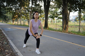 Woman exercises before running at morning.
