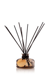 A glass container holds sticks for spreading fragrance. The container is round and dark, while the sticks are black, arranged evenly. This item is suitable for home use.