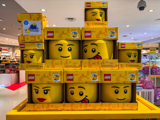 Obraz premium Lego Character Head Containers on Display in a Bright Retail Store