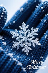 A macro shot of a perfect, intricate crystal snowflake resting on a navy blue knitted winter glove or scarf, with Merry Christmas! below.