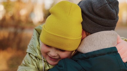 dad hugs daughter. happy family. girl run into arms loving father. happy family concept. chidhood dream. autumn nature. parent hugs child kid. walk autumn park. father rejoices running child. dad day