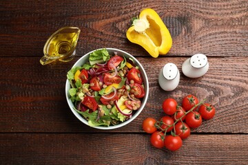 Delicious lentil salad and ingredients on wooden table, flat lay