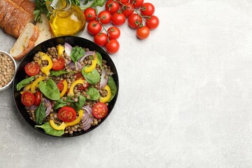 Tasty salad with lentils and vegetables served on grey table, flat lay. Space for text