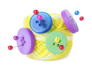 Ball of bright knitting yarn with buttons and pins isolated on white
