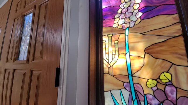 Intricate Stained Glass Featuring Agave And Cactus Motifs Illuminates Hallway With Colorful Patterns