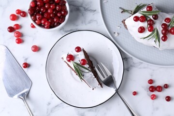 Tasty Christmas cake with cranberries and rosemary served on white marble table, flat lay
