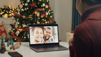 Asia female teacher new normal online remote holiday celebrate christmas new year video conference call with student and their family on computer laptop at house. E-Education distance home education.