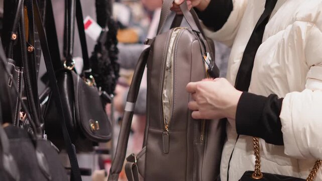 Female hands selecting handbags combining fashion trends, comfort, and personal style