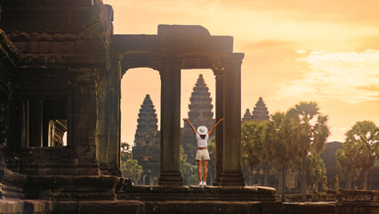 Fototapeta premium Celebrating Sunrise At Angkor Wat Columns, Female Backpacker, Cambodia