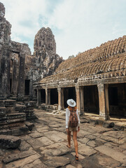 Female Traveler Walking In Bayon Temple Courtyard, Angkor Thom, Cambodia