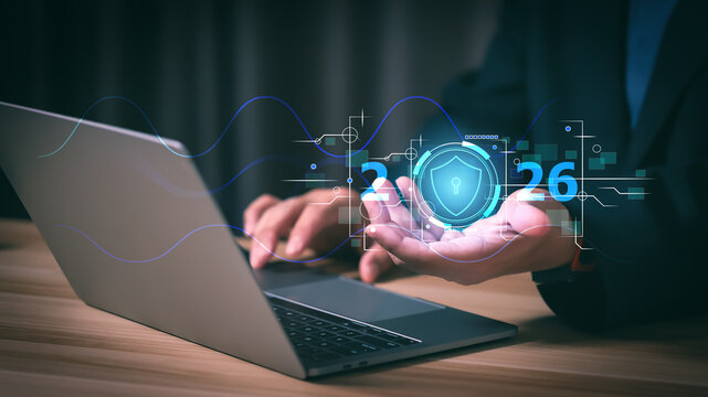 Businessman using laptop with 2026 cyber security interface. Concept of data protection, digital safety, network firewall technology, and privacy system for future corporate business strategy.