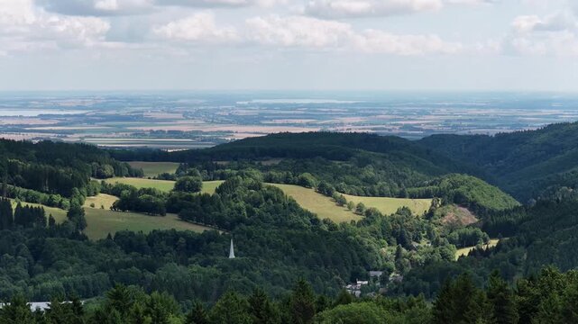 Aerial drone summer panoramic view of Ladek Zdroj town nestled in scenic Klodzko Valley Poland, surrounded by lush greenery and rolling hills of the Golden Mountains