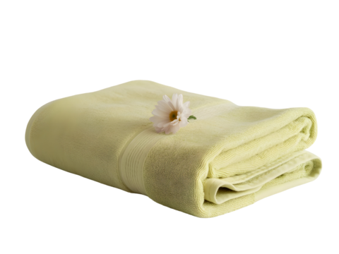 Folded light green bath towel with a delicate white flower on top, ready for relaxation and spa isolated on white background