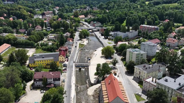 Aerial drone summer panoramic view of Ladek Zdroj town nestled in scenic Klodzko Valley Poland, surrounded by lush greenery and rolling hills of the Golden Mountains