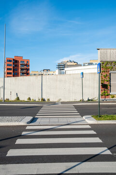 Urban architecture marked by contemporary minimalism and contrast guiding movement across a patterned city street in Oslo, reinforcing functional urban design