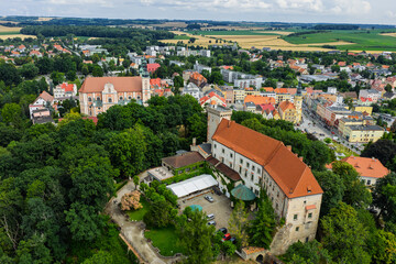 Obraz premium Otmuchow town in summer. Otmuchow panorama from drone aerial fly.Aerial drone view of castle and Church in Otmochow a town in Nysa County, Opole Voivodeship, Poland