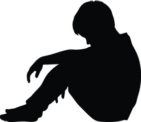 Silhouette of a sad boy sitting alone