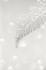 Golden decorative branch on shiny bokeh background. Abstract holiday backdrop. Celebration and party concept. Color of the year 2026 inspired background