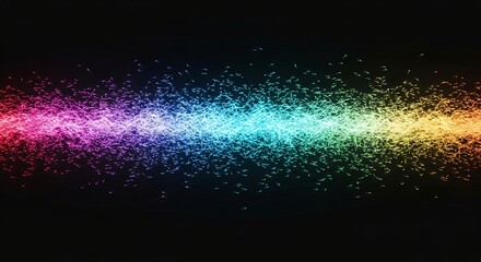 Vibrant sparkling particles forming a horizontal rainbow-colored light trail against a dark background.