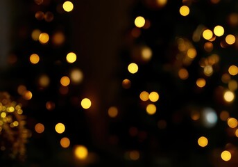 Obraz premium Abstract blurred background with golden bokeh lights on dark surface, perfect for Christmas cards, web banners, and holiday designs as a warm glow texture. Ideal for copy space or overlay use.