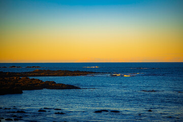 Calm rocky sea coast at sunset