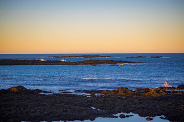 Fototapeta premium Rocky shoreline and calm evening sea