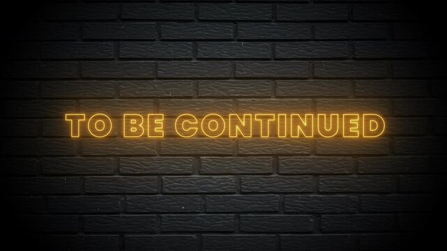 A flickering yellow neon light sign displaying the text to be continued.