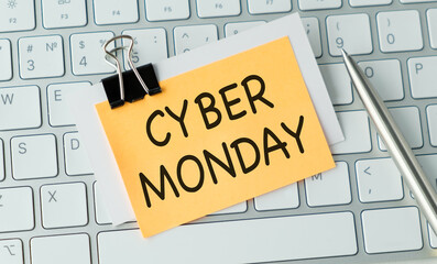 A yellow sticky note on a keyboard that says Cyber Monday