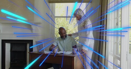 Reviewing papers couple wearing short sleeves and light blouse at home with laptop and blue overlay