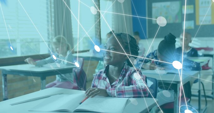 Smiling girl in pink plaid shirt writing at desk in classroom with notebook and digital overlay - Powered by Adobe