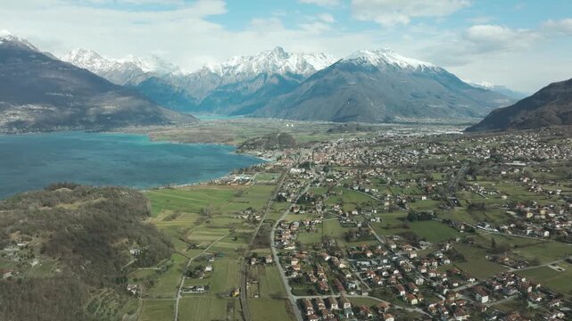 Aerial Panorama of Colico and Lake Como With Snowy Alps on a Clear Day &ndash; 4K Drone Footage