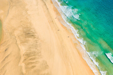Playa de Sotavento is a famous beach on the southeastern coast of Fuerteventura, known for its long stretches of golden sand, turquoise water, and consistent winds