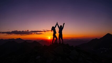 Dynamic video of hikers celebrating summit success with high-five at breathtaking sunset, symbolizing teamwork and achievement in stunning mountain landscape, motivational outdoor adventure