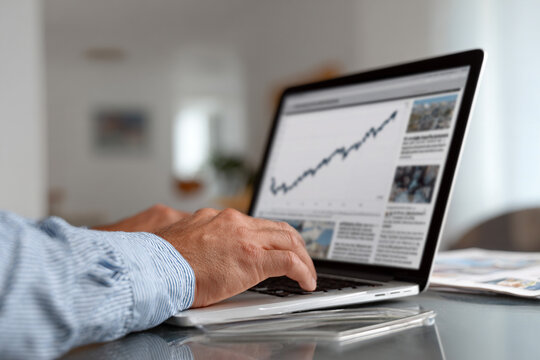 A businessman reviewing a rising economy graph.