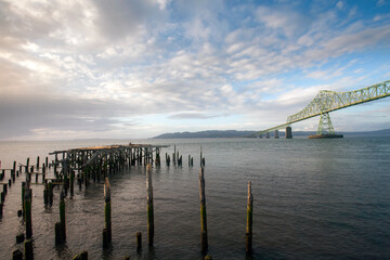 The Astoria-Megler bridge connecting Oregon to Washington with a ruined pier in the foreground.
