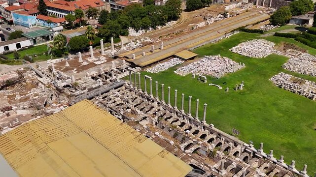 Aerial view of the ancient Agora archaeological site with Roman columns and ruins in the historical center of Izmir, Turkey on a sunny day. Famous cultural heritage and tourist landmark.