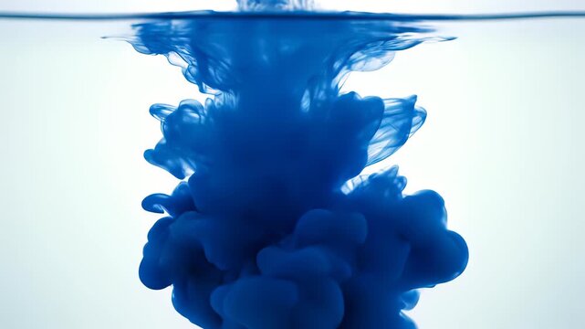 Blue ink flowing into calm water, capturing the creative concept of imagination and innovation, perfect for projects seeking to evoke curiosity, playfulness, or innovative thinking in 4K UHD.